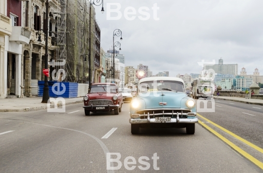 American classic cars driving on the street in Havana