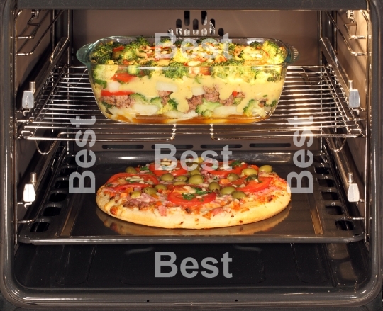 Baking pizza and casserole dish in oven