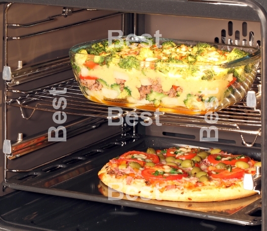 Baking pizza and casserole dish in oven