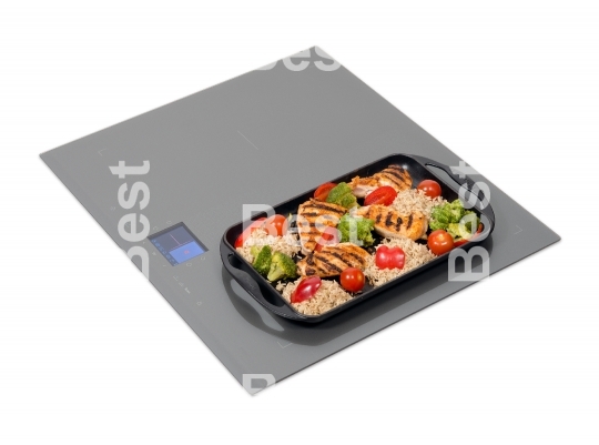 Grey glass induction hob with roast chicken