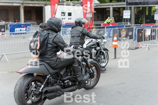 Harley Davidson motorcycle riders in front of the gate "Harley-Davidson Super Rally 2013"