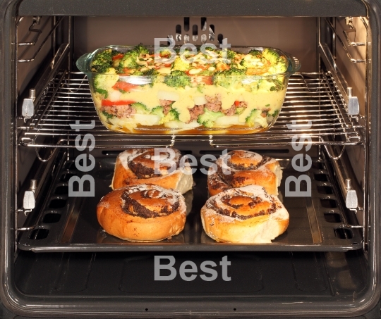 Poppy seed rolls and casserole dish in oven