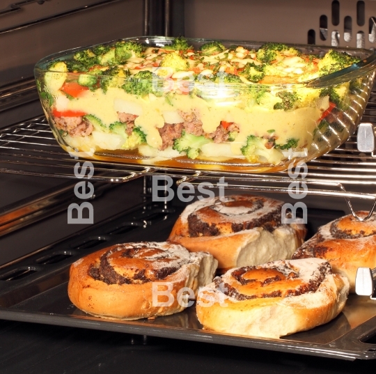 Poppy seed rolls and casserole dish in oven