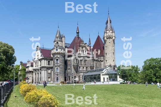 Tourists enjoying the beautiful weather visit the palace in Moszna.