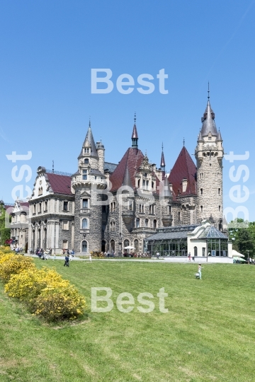 Tourists enjoying the beautiful weather visit the palace in Moszna.