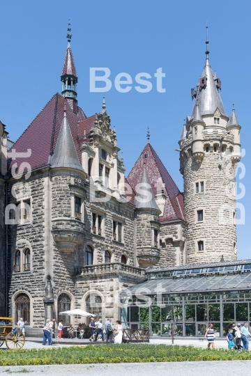 Tourists enjoying the beautiful weather visit the palace in Moszna.