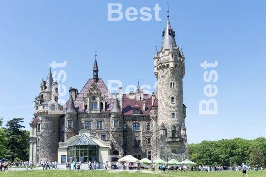 Tourists enjoying the beautiful weather visit the palace in Moszna.