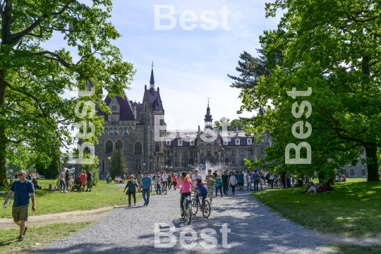 Tourists enjoying the beautiful weather visit the palace in Moszna.