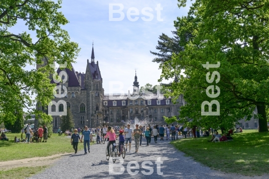 Tourists enjoying the beautiful weather visit the palace in Moszna.