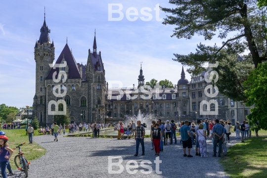 Tourists enjoying the beautiful weather visit the palace in Moszna.