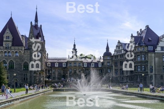 Tourists enjoying the beautiful weather visit the palace in Moszna.