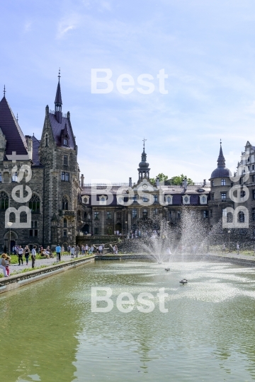 Tourists enjoying the beautiful weather visit the palace in Moszna.