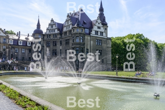 Tourists enjoying the beautiful weather visit the palace in Moszna.