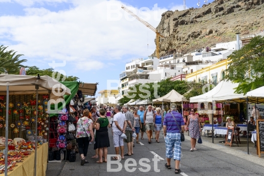 Tourists walking around the city in Puerto de Mogan