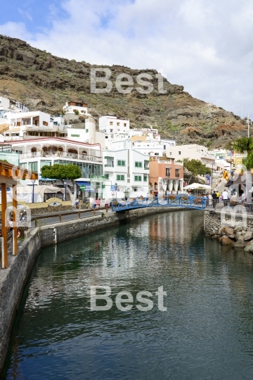 Tourists walking around the city in Puerto de Mogan