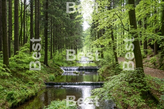 Water stream cascade falls near old gold mine in Zlate Mesto, Czech Republic. 