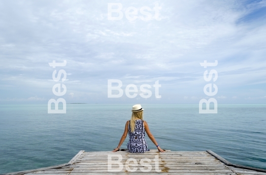 Young woman relax on the dock in Cayo Guillermo