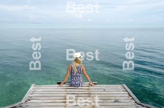 Young woman relax on the dock in Cayo Guillermo