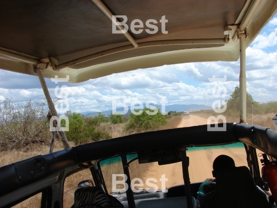 A road by african savanna. Safari in Tsavo National Park