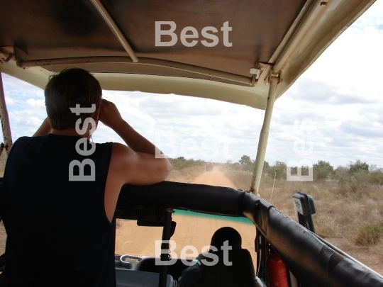 A road by african savanna. Safari in Tsavo National Park