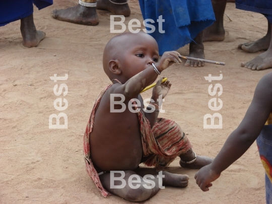 Child in a traditional Masai village