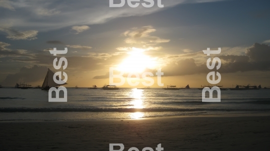 Sail boats on the ocean at sunset