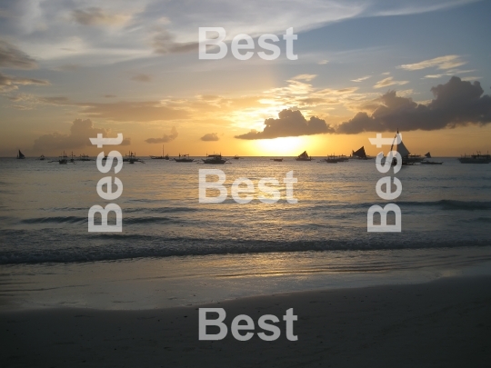 Sail boats on the ocean at sunset